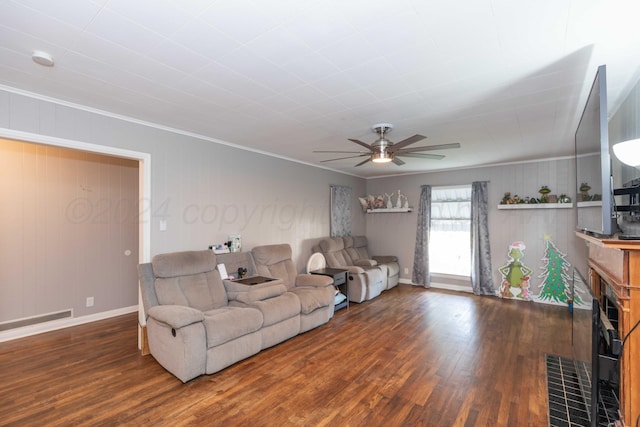 living room with a fireplace, dark hardwood / wood-style floors, crown molding, and ceiling fan