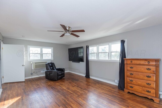 unfurnished room with dark wood-type flooring, ceiling fan, and a wall mounted air conditioner