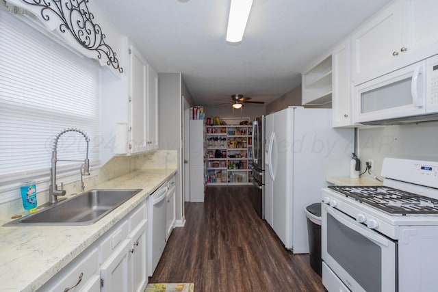 kitchen with white cabinetry, sink, ceiling fan, dark hardwood / wood-style floors, and white appliances