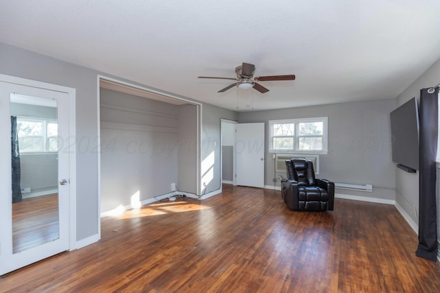 unfurnished living room with ceiling fan, a wall unit AC, and dark hardwood / wood-style floors