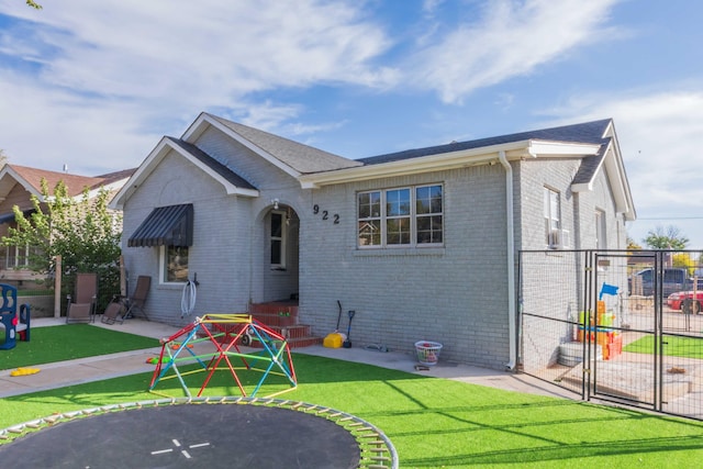 rear view of property with a patio and a yard