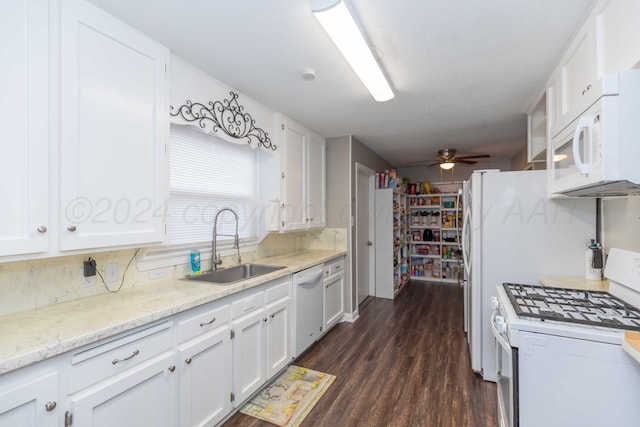 kitchen with dark hardwood / wood-style flooring, white appliances, sink, and white cabinets