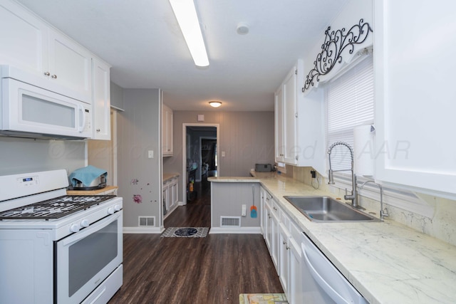 kitchen featuring dark wood-type flooring, white appliances, sink, and white cabinets