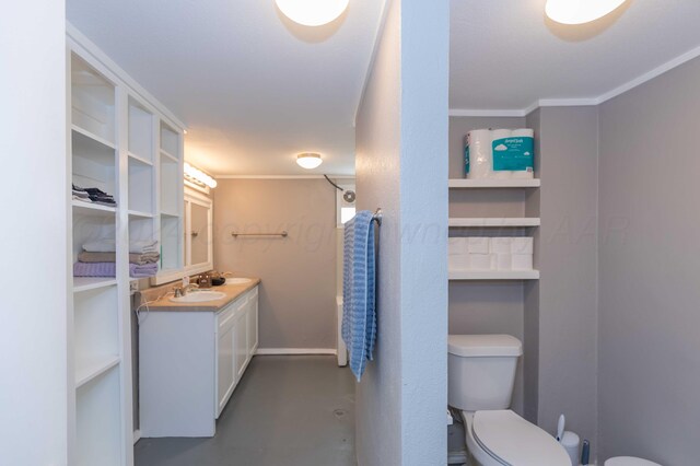 bathroom with concrete flooring, vanity, toilet, and ornamental molding