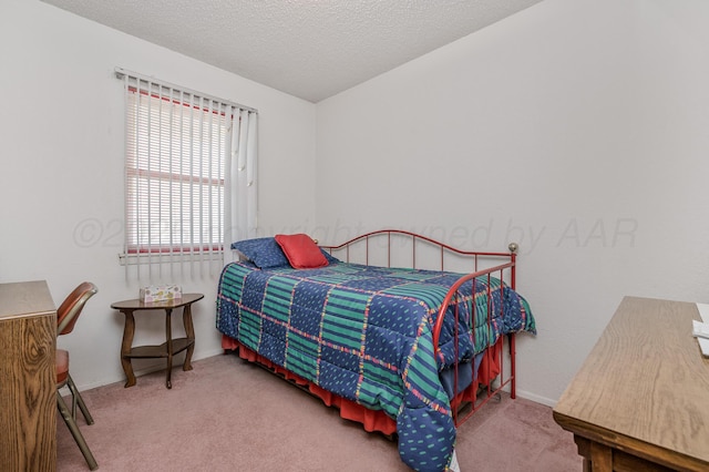 carpeted bedroom featuring baseboards and a textured ceiling