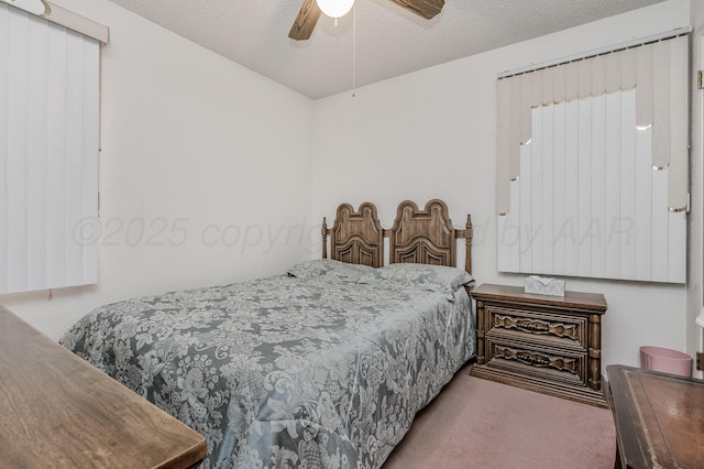 carpeted bedroom with a textured ceiling and ceiling fan