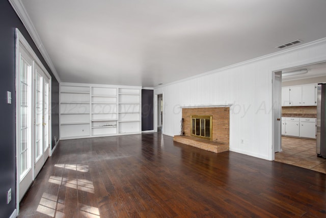 3203 S Austin St, Amarillo, TX 79109 - unfurnished living room featuring ornamental molding, hardwood / wood-style floors, and a fireplace