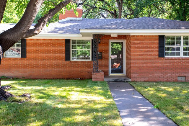 3203 S Austin St, Amarillo, TX 79109 - ranch-style house featuring brick siding, roof with shingles, and a front yard