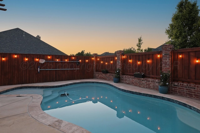 6817 Baccus Dr, Amarillo, TX 79124 - pool at dusk with a fenced backyard