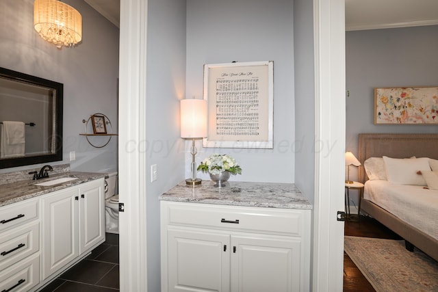 6817 Baccus Dr, Amarillo, TX 79124 - bedroom featuring a sink, ornamental molding, and dark tile patterned flooring