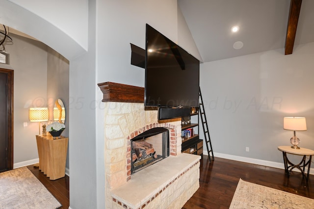 6817 Baccus Dr, Amarillo, TX 79124 - living room featuring dark wood-type flooring, baseboards, a stone fireplace, vaulted ceiling, and recessed lighting