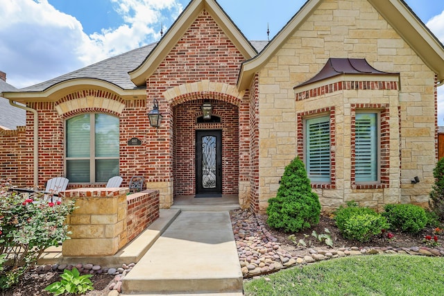 6817 Baccus Dr, Amarillo, TX 79124 - doorway to property featuring stone siding, roof with shingles, and brick siding