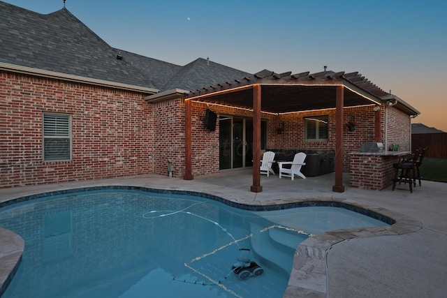 6817 Baccus Dr, Amarillo, TX 79124 - pool at dusk featuring an outdoor pool, a pergola, and a patio area