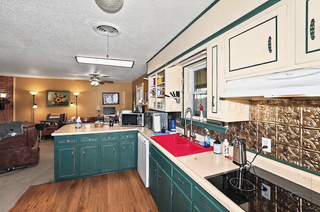 6005 Gainsborough Rd, Amarillo, TX 79106 - kitchen featuring stainless steel microwave, a sink, black electric cooktop, open floor plan, and a peninsula