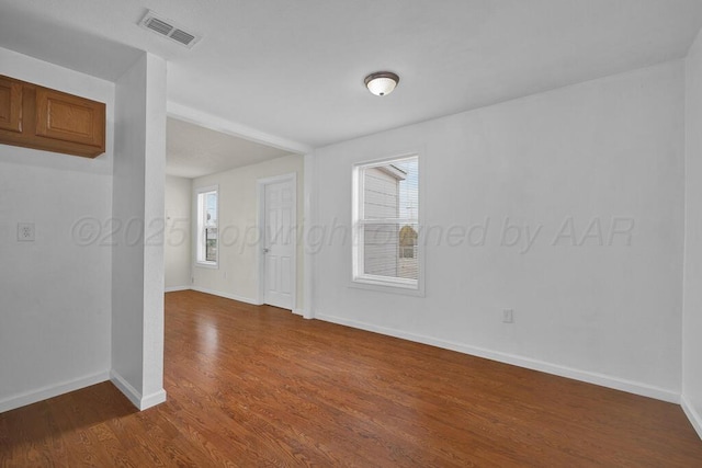 unfurnished room featuring hardwood / wood-style flooring and a healthy amount of sunlight