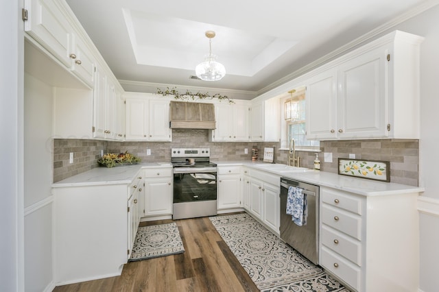 kitchen with white cabinetry, sink, appliances with stainless steel finishes, dark hardwood / wood-style floors, and pendant lighting