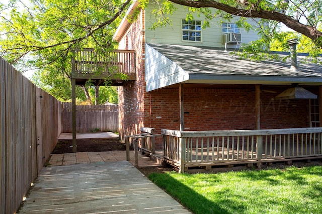3925 Gatewood St, Amarillo, TX 79109 - view of home's exterior featuring a fenced backyard, a wooden deck, and brick siding