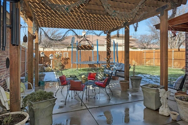 7908 London Ct, Amarillo, TX 79119 - view of patio / terrace featuring a trampoline, a pergola, and a fenced backyard