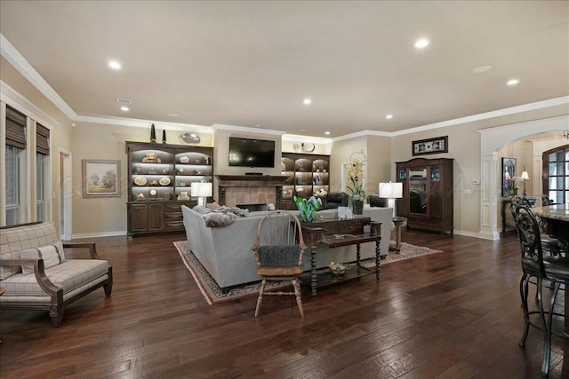 7908 London Ct, Amarillo, TX 79119 - living area with a tile fireplace, dark wood-style flooring, baseboards, arched walkways, and recessed lighting