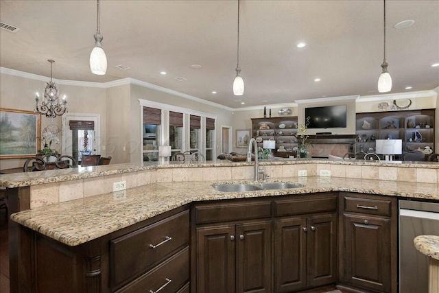 7908 London Ct, Amarillo, TX 79119 - kitchen featuring crown molding, dark brown cabinets, light stone countertops, and a sink