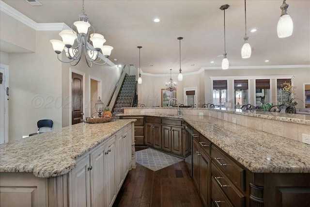 7908 London Ct, Amarillo, TX 79119 - kitchen featuring a large island, dishwasher, a chandelier, dark wood-style floors, and light stone countertops