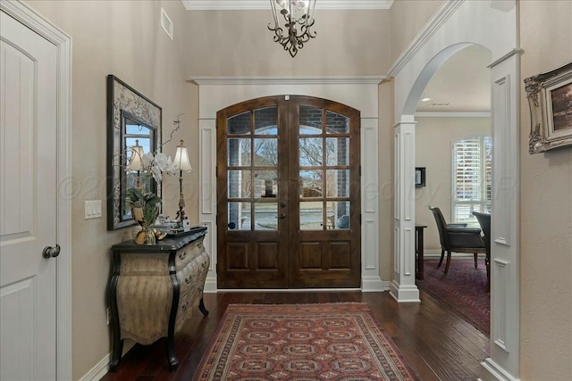 7908 London Ct, Amarillo, TX 79119 - entryway with arched walkways, dark wood-style flooring, french doors, and crown molding