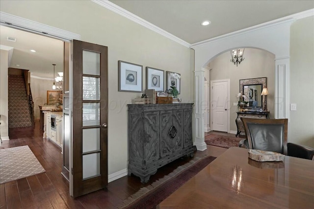 7908 London Ct, Amarillo, TX 79119 - interior space with visible vents, baseboards, arched walkways, ornamental molding, and dark wood-style floors