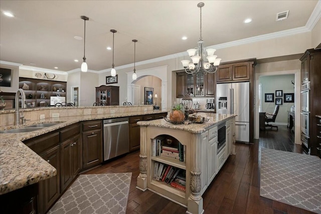 7908 London Ct, Amarillo, TX 79119 - kitchen featuring a sink, a notable chandelier, dark brown cabinetry, visible vents, and appliances with stainless steel finishes