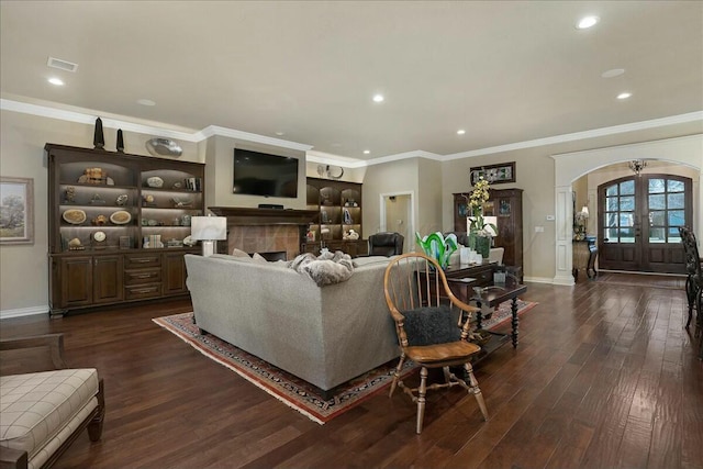 7908 London Ct, Amarillo, TX 79119 - living area featuring french doors, ornamental molding, visible vents, arched walkways, and dark wood-style floors