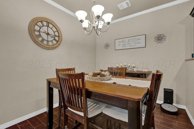 dining room featuring crown molding, wood finish floors, visible vents, and an inviting chandelier