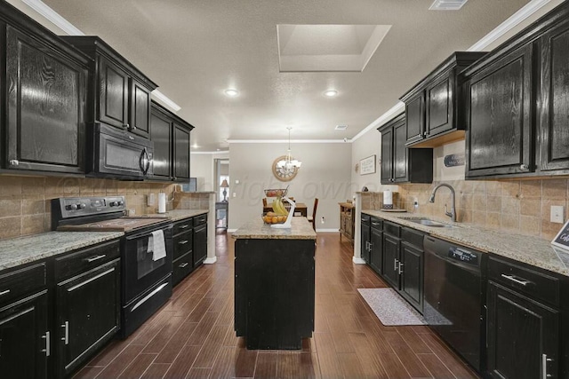 kitchen with dark cabinets, a center island, a sink, and black appliances