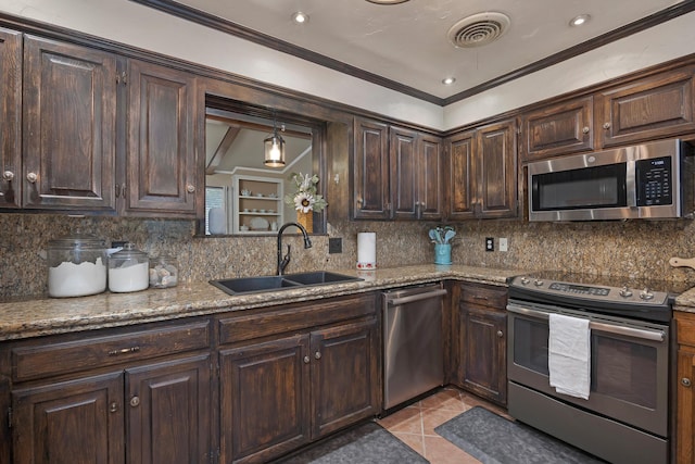 6410 Hamstead Dr, Amarillo, TX 79109 - kitchen featuring stainless steel appliances, dark brown cabinets, decorative backsplash, ornamental molding, and light stone counters