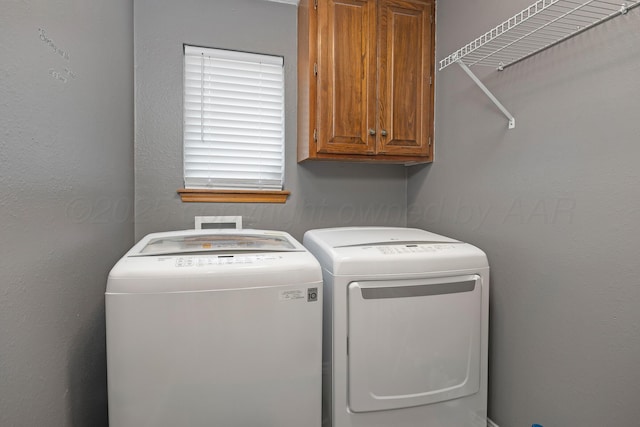 6410 Hamstead Dr, Amarillo, TX 79109 - laundry area featuring cabinet space and independent washer and dryer