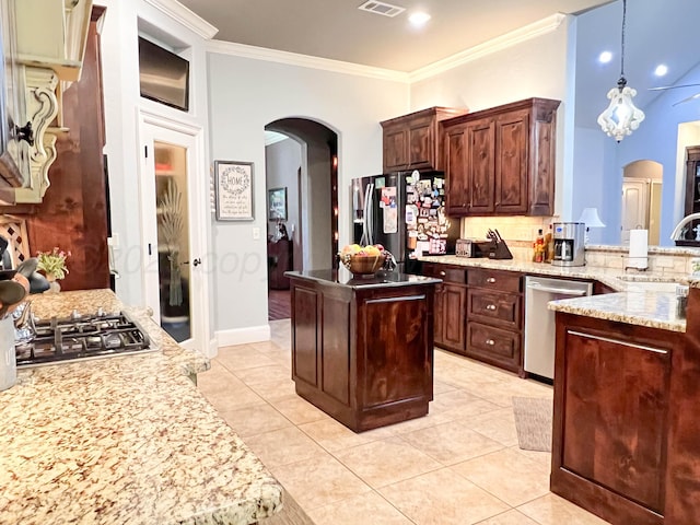 7507 Continental Pkwy, Amarillo, TX 79119 - kitchen featuring arched walkways, stainless steel appliances, backsplash, light tile patterned floors, and ornamental molding