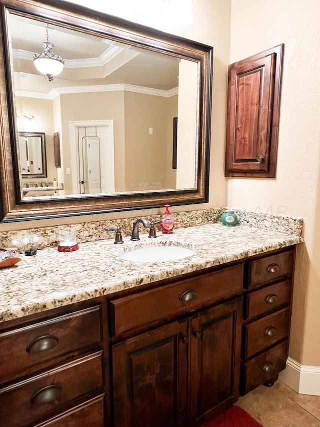 7507 Continental Pkwy, Amarillo, TX 79119 - bathroom with vanity, crown molding, a tray ceiling, and tile patterned floors