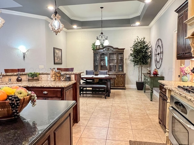 7507 Continental Pkwy, Amarillo, TX 79119 - kitchen with a chandelier, crown molding, oven, a raised ceiling, and light tile patterned flooring