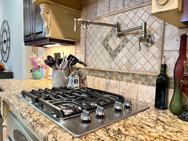 7507 Continental Pkwy, Amarillo, TX 79119 - kitchen featuring stainless steel gas cooktop, tasteful backsplash, and light stone counters