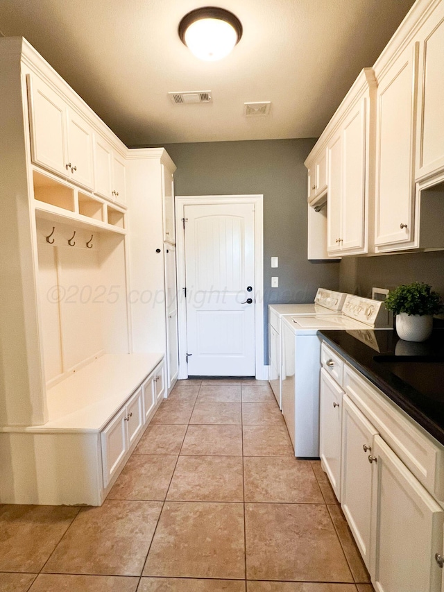 7507 Continental Pkwy, Amarillo, TX 79119 - laundry area featuring washing machine and dryer, cabinet space, and light tile patterned flooring