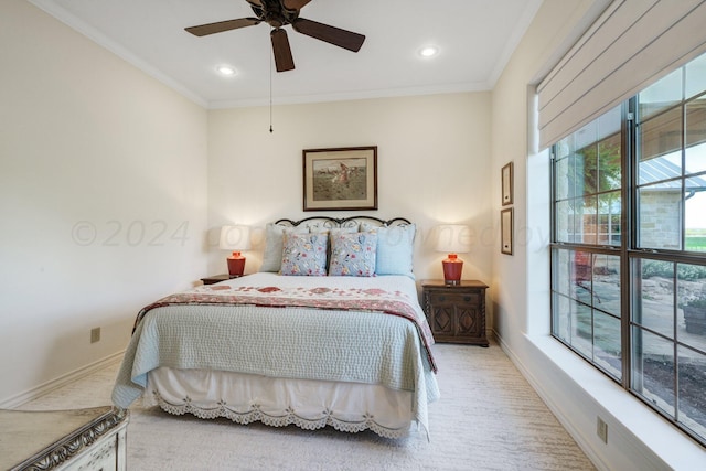 carpeted bedroom with ceiling fan and crown molding