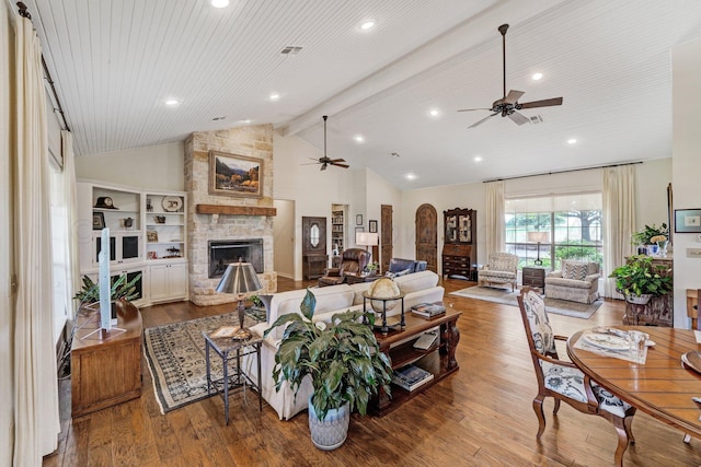 living room with a fireplace, beamed ceiling, hardwood / wood-style flooring, and high vaulted ceiling