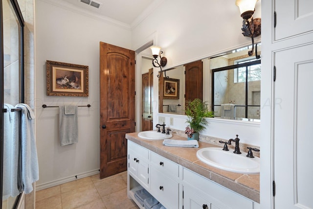 bathroom featuring a shower with shower door, vanity, tile patterned floors, and crown molding