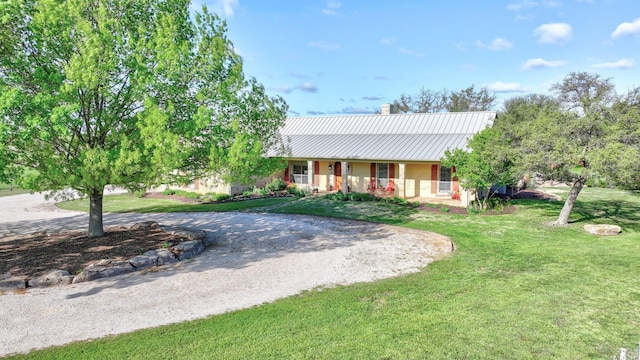 ranch-style home with a front yard and covered porch