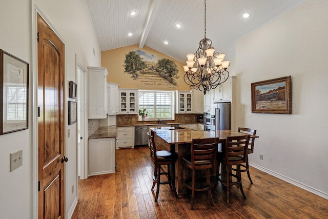 dining space with a notable chandelier, dark hardwood / wood-style floors, beam ceiling, high vaulted ceiling, and wood ceiling