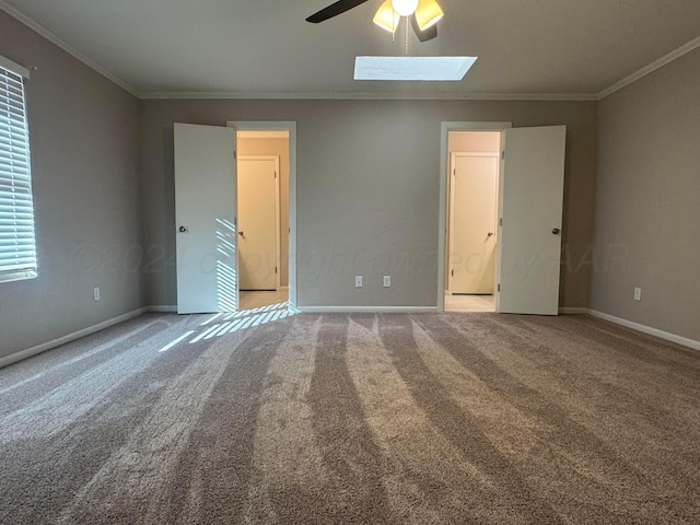 3717 Farwell Dr, Amarillo, TX 79109 - unfurnished bedroom featuring crown molding, a skylight, carpet floors, and baseboards