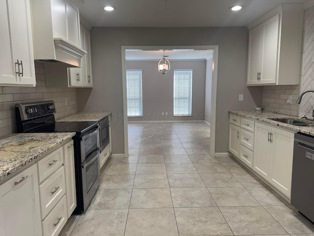 3717 Farwell Dr, Amarillo, TX 79109 - kitchen featuring range with two ovens, a sink, wall chimney exhaust hood, dishwashing machine, and backsplash