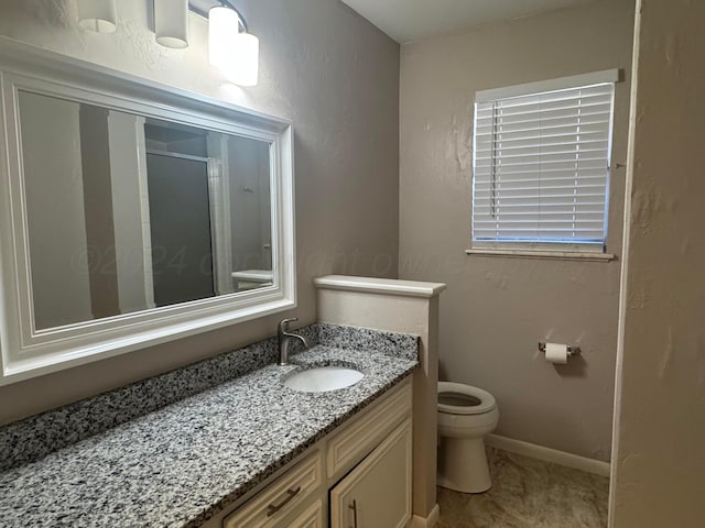 3717 Farwell Dr, Amarillo, TX 79109 - bathroom featuring toilet, vanity, a shower stall, and baseboards