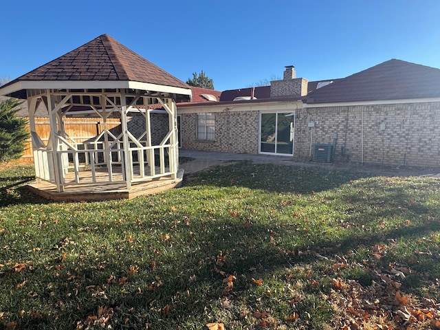 3717 Farwell Dr, Amarillo, TX 79109 - rear view of property featuring a gazebo, brick siding, a chimney, central AC unit, and a patio