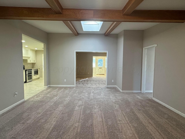3717 Farwell Dr, Amarillo, TX 79109 - empty room with beamed ceiling, light colored carpet, a skylight, and baseboards
