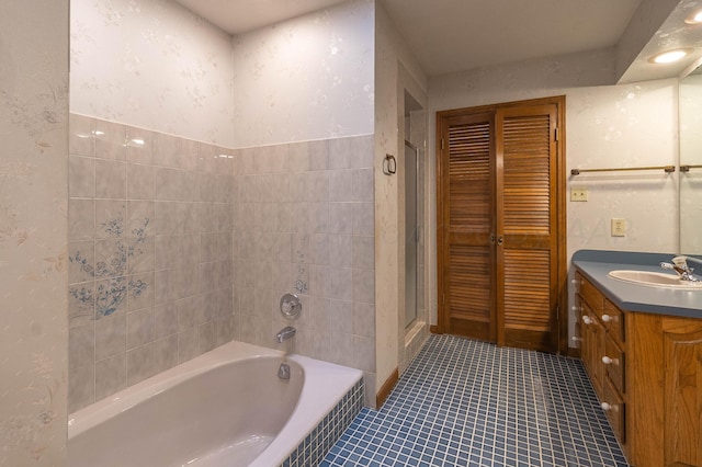 bathroom with vanity, tile patterned flooring, and shower with separate bathtub