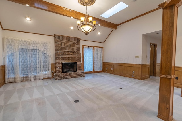 unfurnished living room featuring a brick fireplace, light carpet, a chandelier, ornamental molding, and beamed ceiling